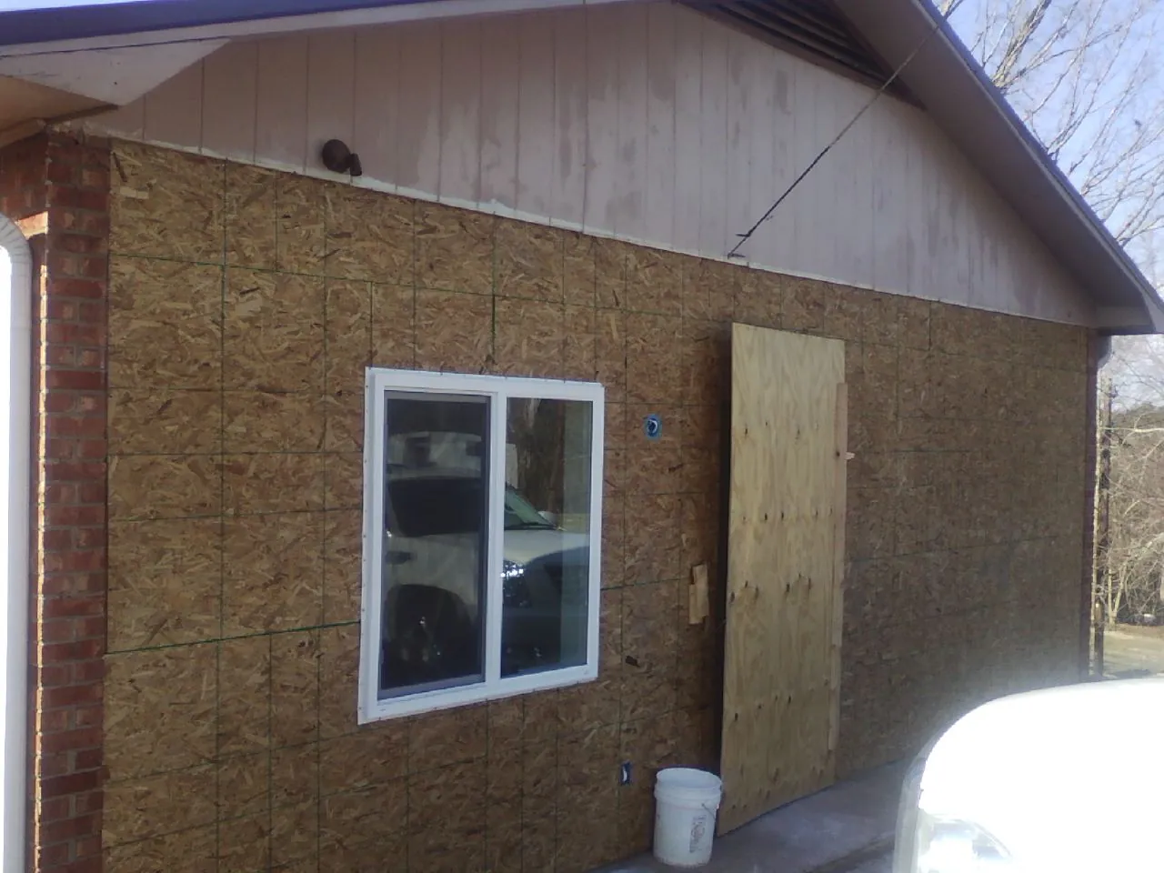 OSB sheathing on a garage addition wall before siding in Table Rock