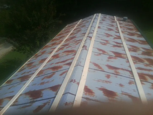 Rusted metal roof panels with new wood purlins before replacement — Storm Damage Roof Repair in Table Rock by Roofing Brothers
